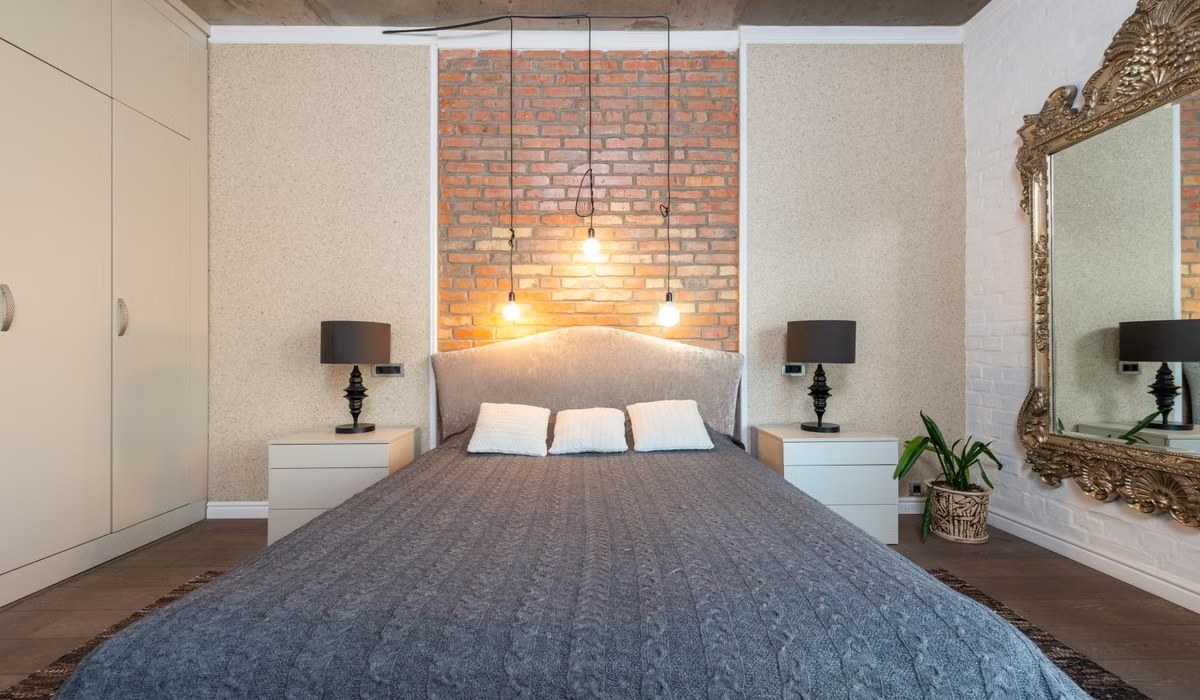 Contemporary bedroom with brick accent wall and elegant decor