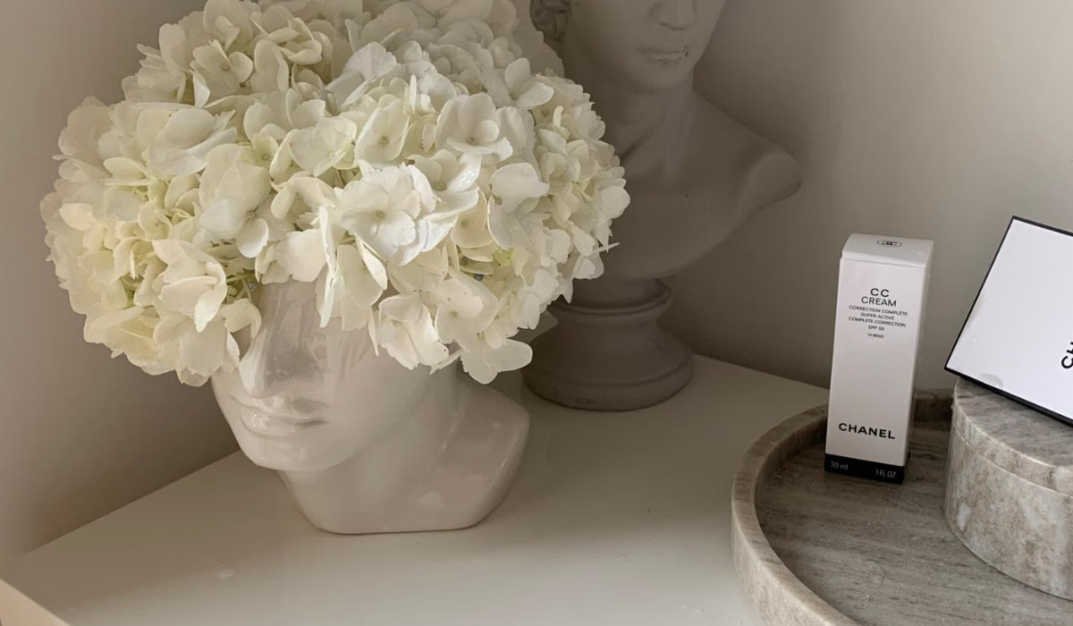 Bathroom counter styled with a tray holding beauty and self-care products