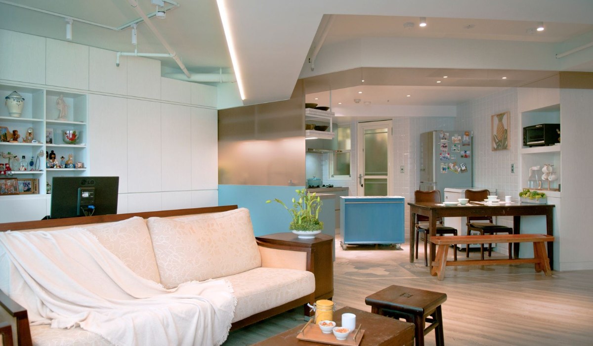Small, organized apartment living room with cozy seating and storage