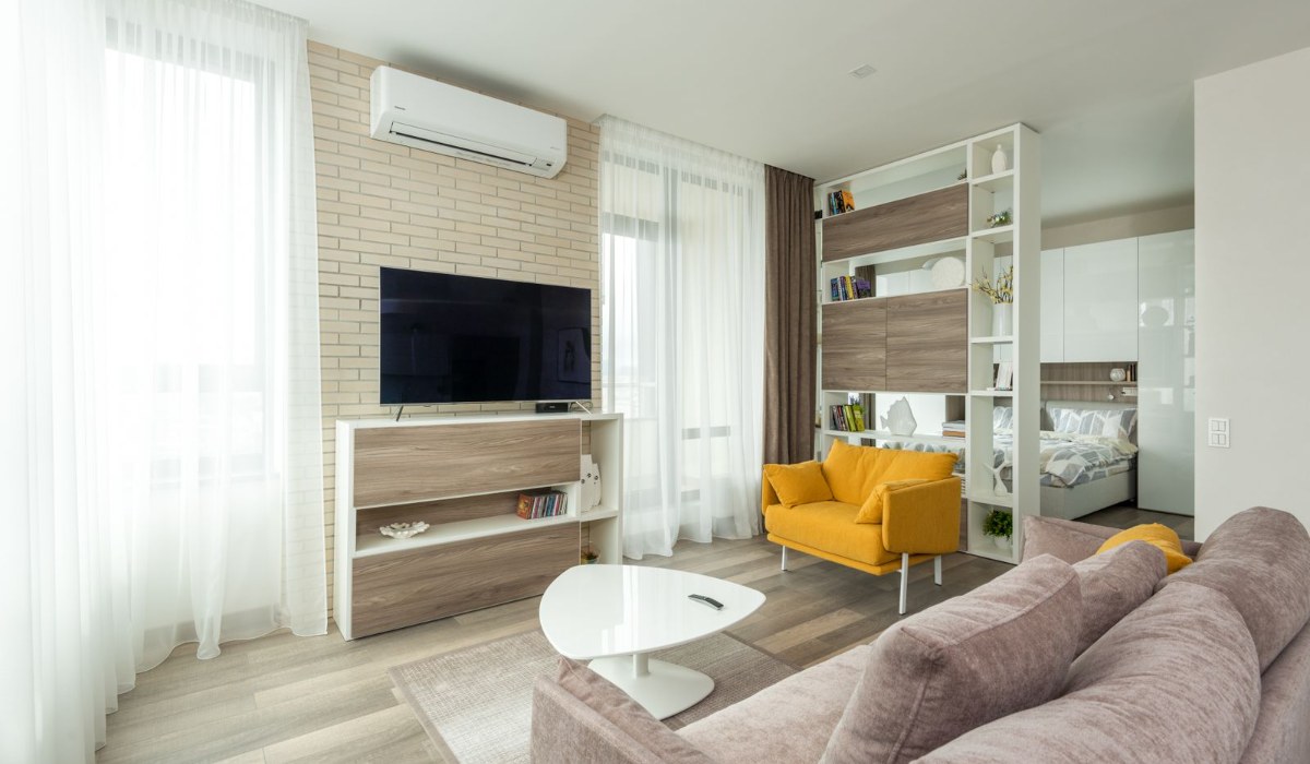 Compact bedroom with floating shelves and storage bins in a small apartment