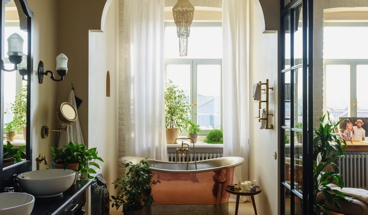 Cozy bathroom with a freestanding tub, plants, and a soft rug