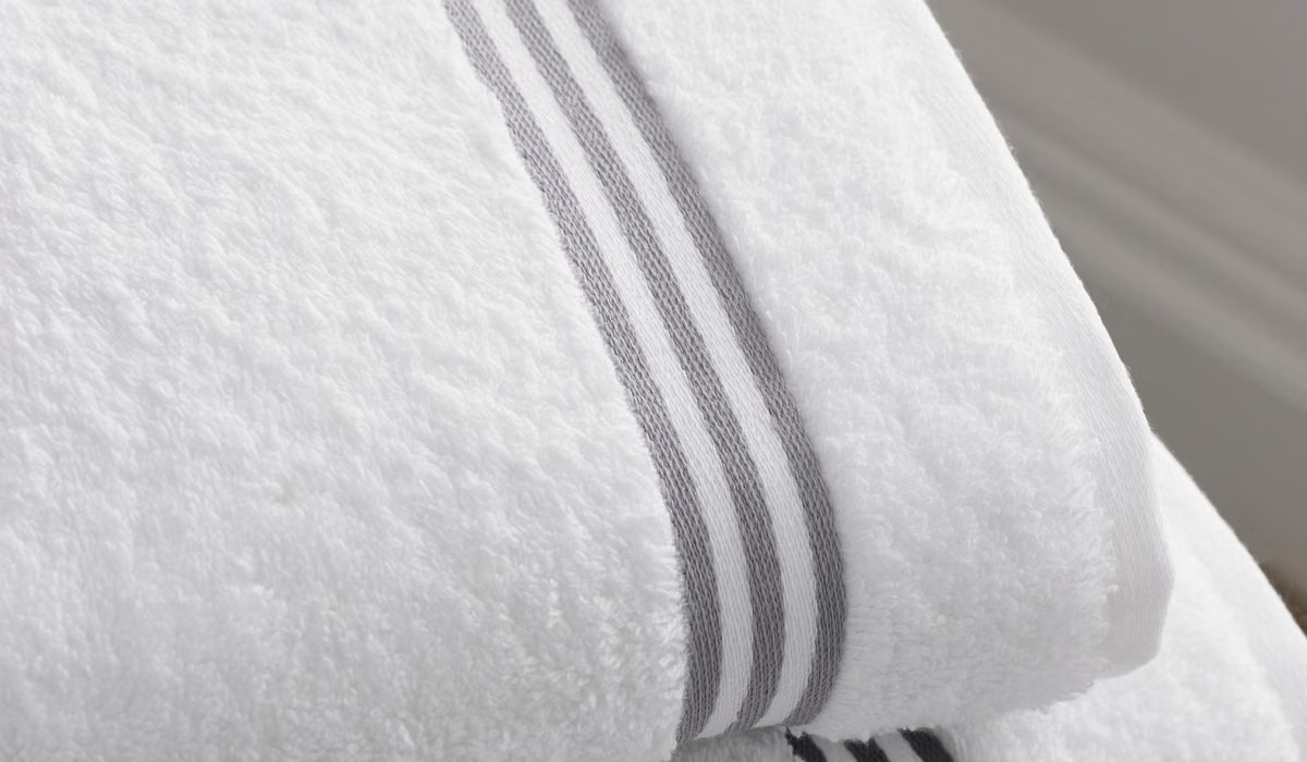 Folded white bath towels in a bright bathroom