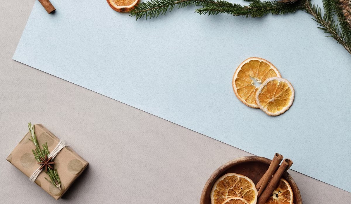 Dried orange slices and cinnamon sticks in a wooden bowl for a simmer pot