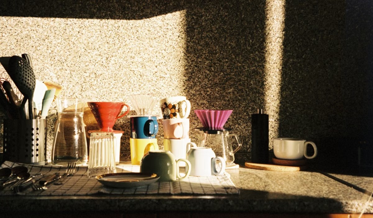 Sunlit kitchen counter with coffee equipment