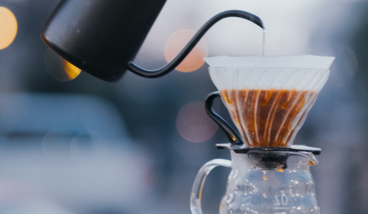Pouring hot water over coffee in a pour-over dripper