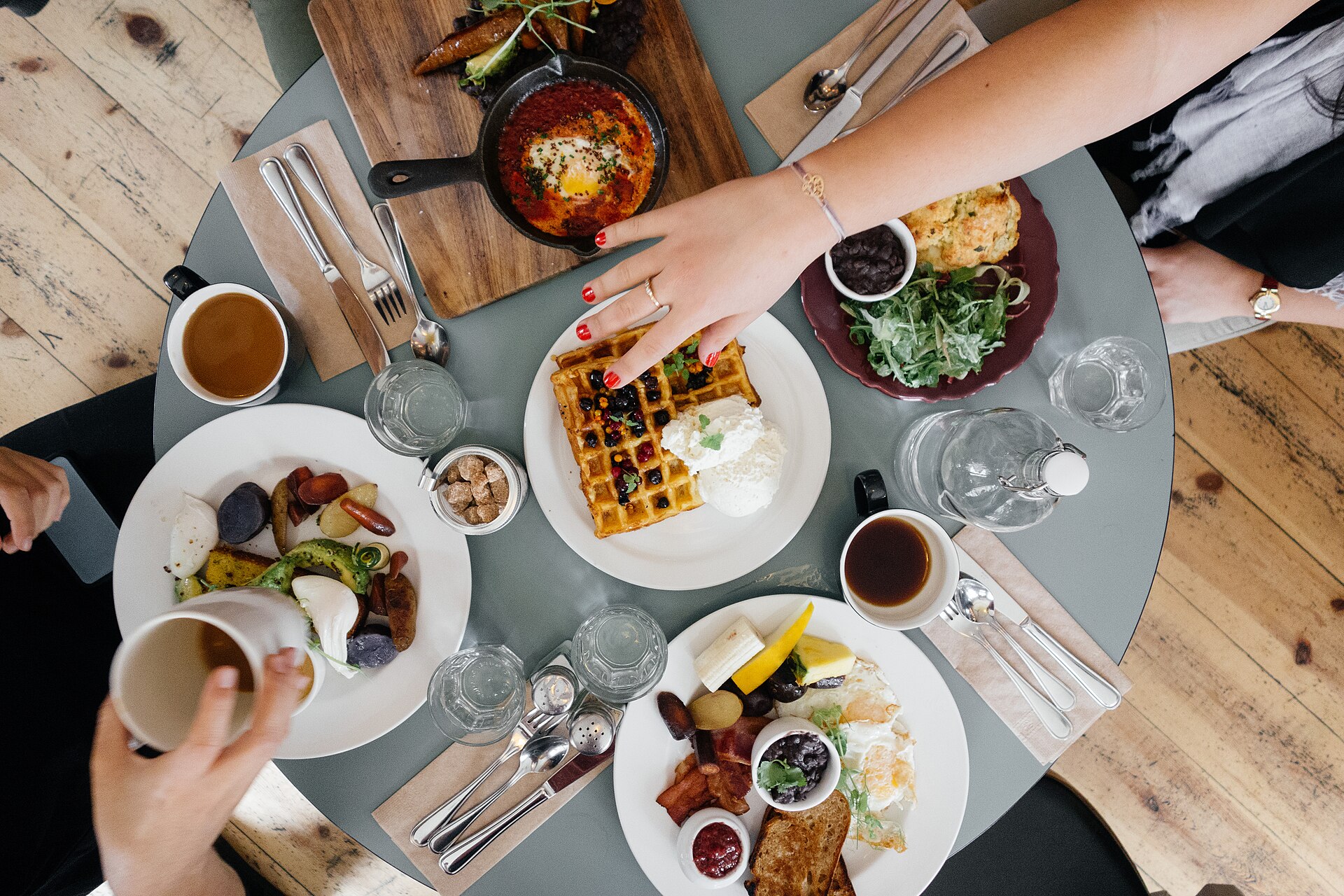 Friends sharing a bright brunch table